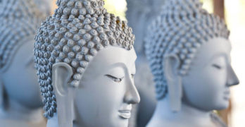 Statues of the Buddha sitting in meditation